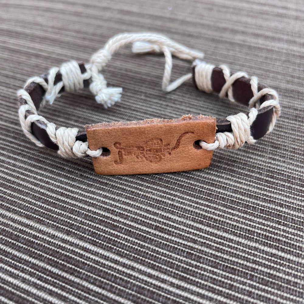 Woman’s leather and rope bracelet.